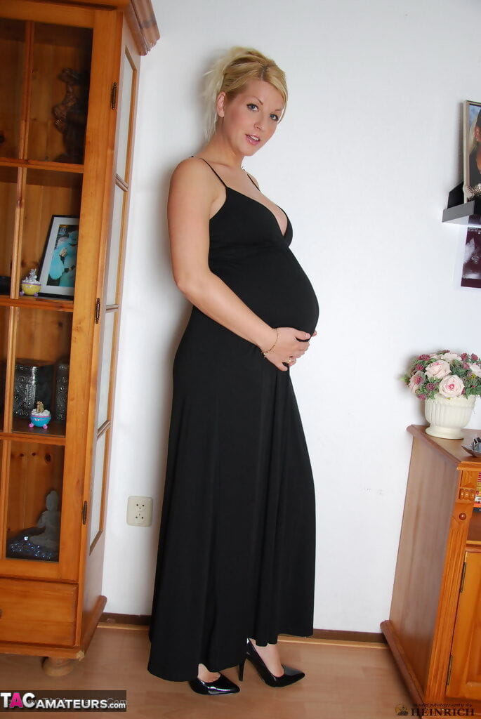 Pregnant blonde beauty drops gown to reveal her swollen belly & full milkers page 1