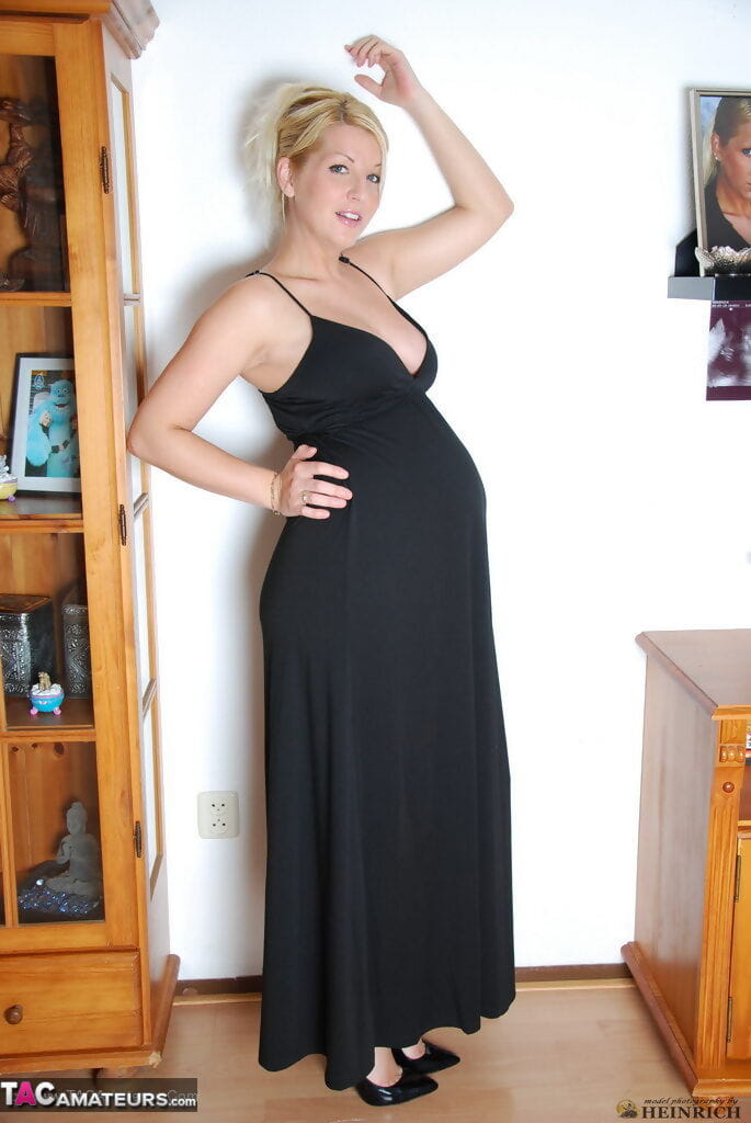 Pregnant blonde beauty drops gown to reveal her swollen belly & full milkers page 1