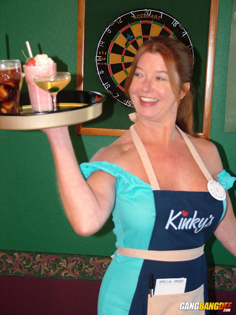 Mature lady Dee Delmar goes topless while waiting tables in a pub page 1