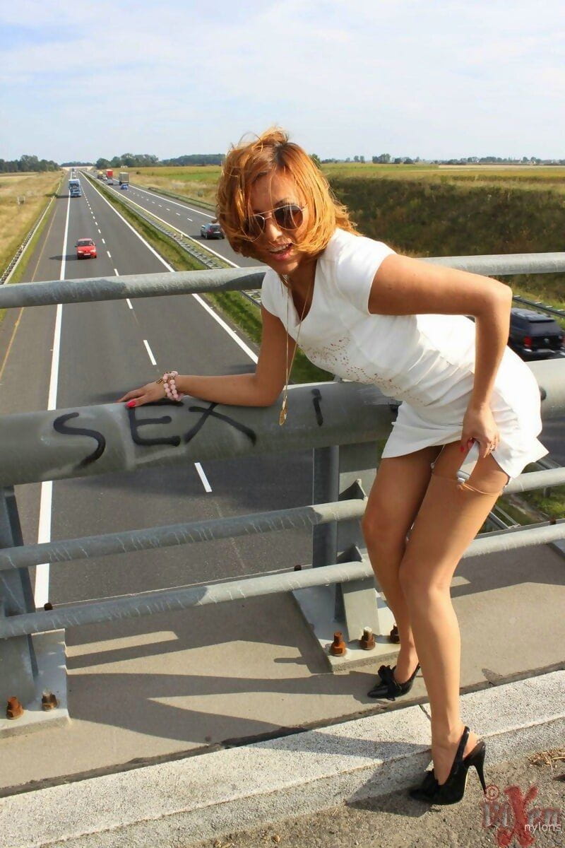 Naughty female Vixen flashes no panty upskirts on an overpass in sunglasses page 1