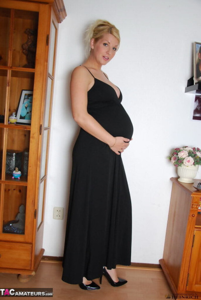 Pregnant blonde beauty drops gown to reveal her swollen belly & full milkers