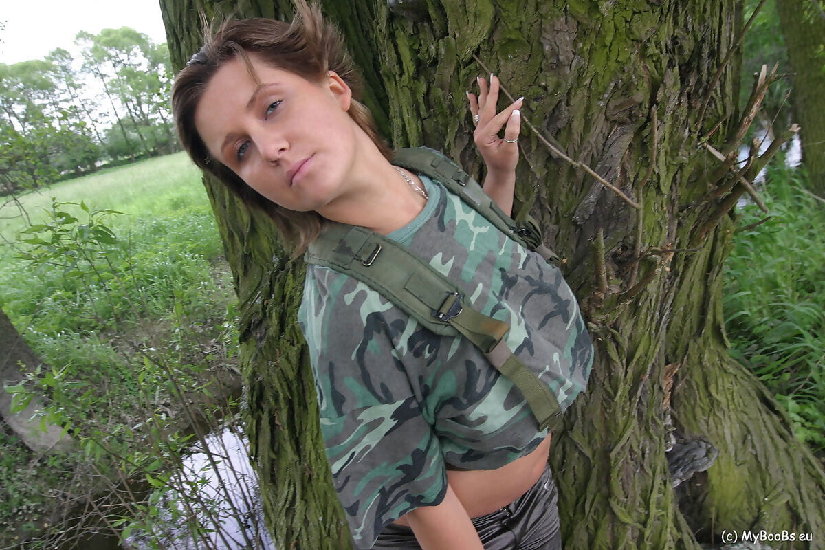 Solo girl Lea Ticia releases her huge tits from military fatigues under a tree page 1