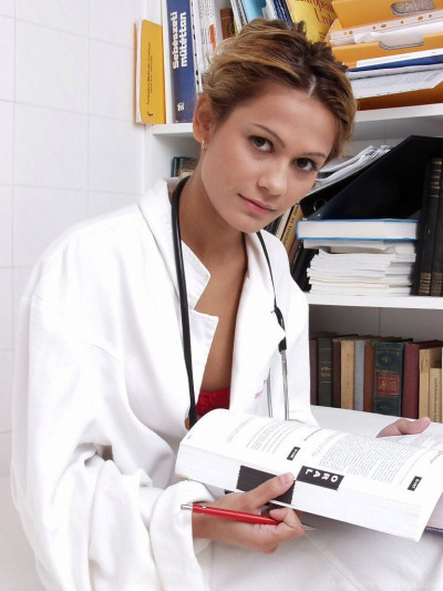 Solo girl removes her lab coat to model naked other than a stethoscope